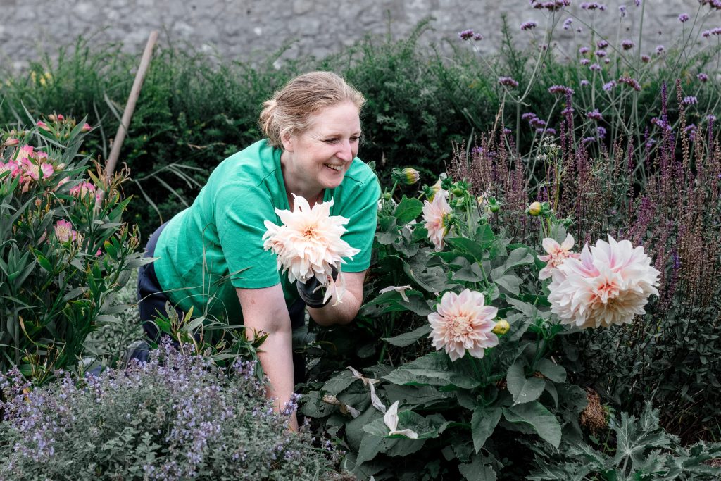 Lynda with Dahlia Cafe au Lait in full flower