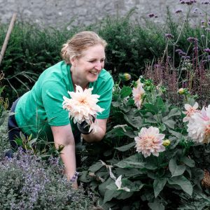 Lynda with Dahlia Cafe au Lait in full flower